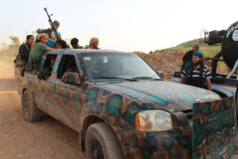 © Reuters. Rebel fighters sit on a pick-up truck in Tel Mastouma, after they said they took control of the area which overlooks the Mastouma military base, south of the city of Idlib