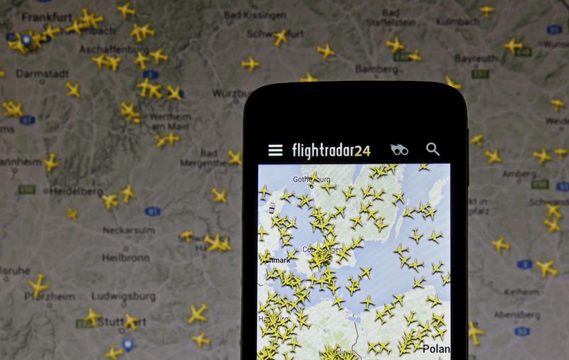 © Reuters. The Flightradar24 application is pictured on a smartphone in front of a computer screen displaying the website in this illustration taken in Zenica