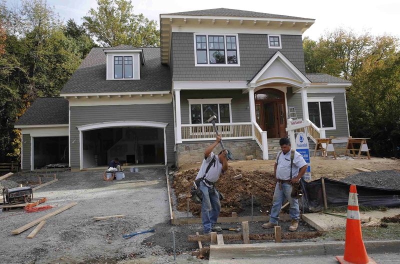 © Reuters. File photo of construction workers building a new home in Vienna Virginia