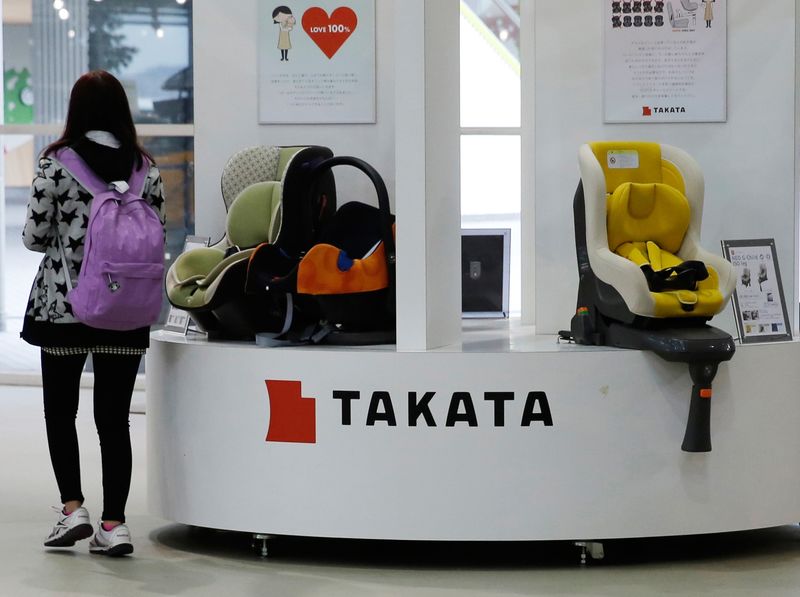 © Reuters. Visitor walks past displays of Takata Corp at a showroom for vehicles in Tokyo in this file photo