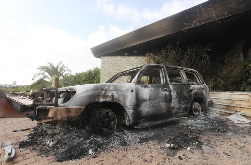 © Reuters. A burnt car is parked at the U.S. consulate, which was attacked and set on fire by gunmen yesterday, in Benghazi