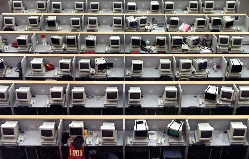 © Reuters. A lone Chinese trader takes a nap during midday break at Shanghai Stock Exchange February 10, 2003. ..