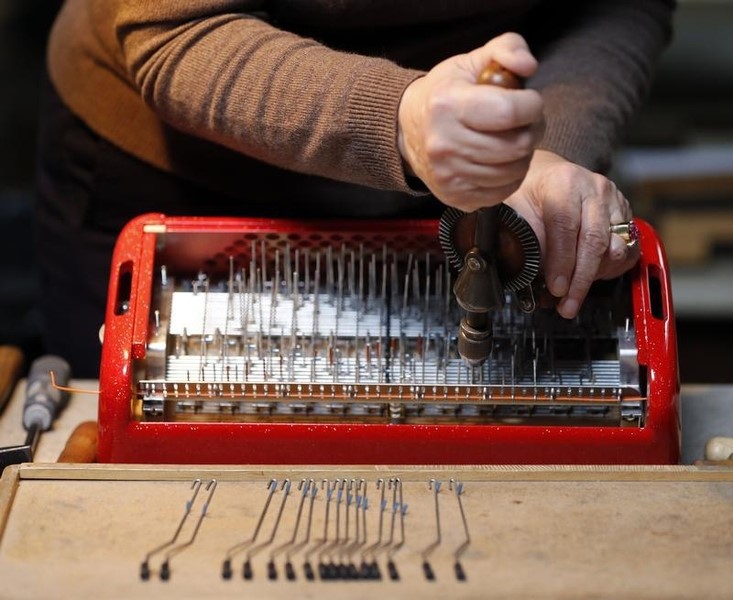 © Reuters. An employee works on an accordion at the Maugein factory in Tulle, in the Correze region central France