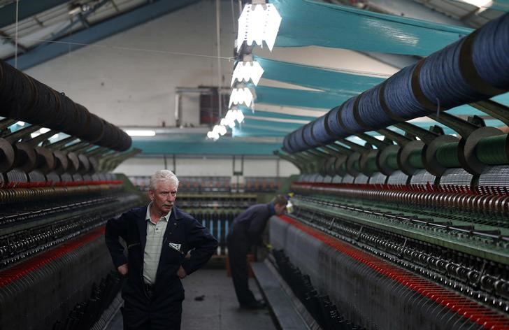 © Reuters. Employees at Harris Tweed Hebrides work in the factory on the Isle of Lewis in the Outer Hebrides