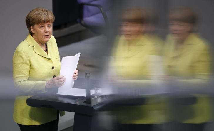 © Reuters. Chanceler alemã, Angela Merkel, tem imagem refletida em janela durante fala no Bundestag, em Berlim