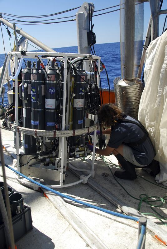 © Reuters. Handout of scientists aboard the Tara Oceans vessel prepare to lower a CTD device into the ocean depths