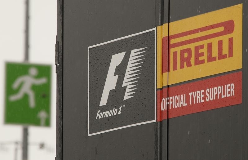 © Reuters. An emergency exit sign is pictured next to a truck of Italian official Formula One tyre supplier Pirelli in the paddock area of the Nuerburgring racing circuit