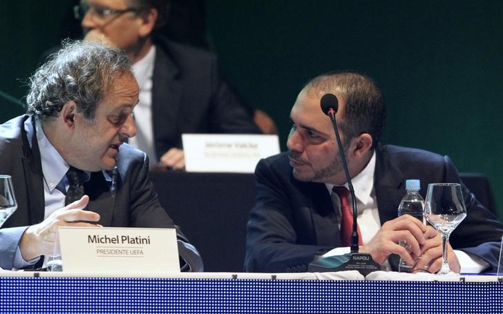 © Reuters. UEFA President Michel Platini speaks with FIFA Vice President Prince Ali bin al-Hussein of Jordan during the CONMEBOL ordinary congress in Luque