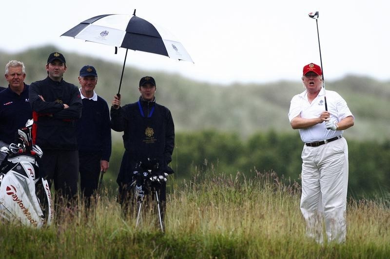 © Reuters. Real estate magnate Trump plays golf during the opening of his Trump International Golf Links golf course near Aberdeen, northeast Scotland