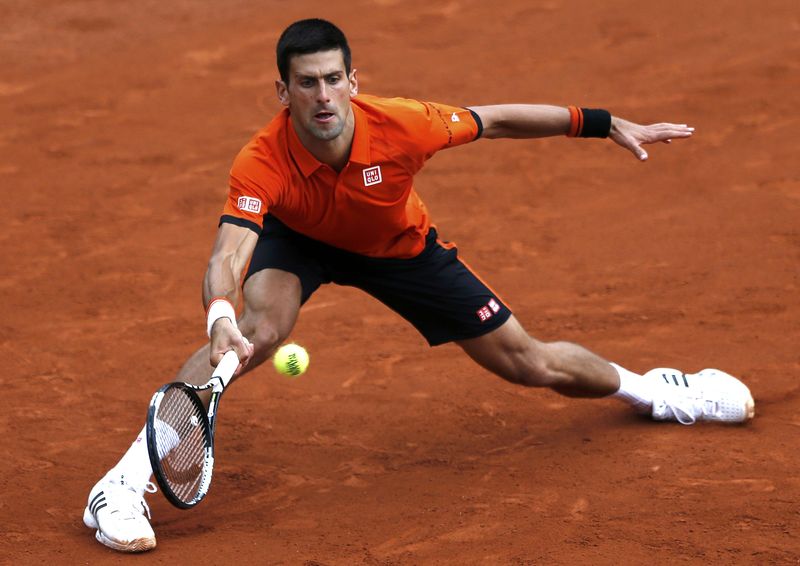 © Reuters. Novak Djokovic of Serbia plays a shot to Jarkko Nieminen of Finland during their men's singles match at the French Open tennis tournament at the Roland Garros stadium in Paris