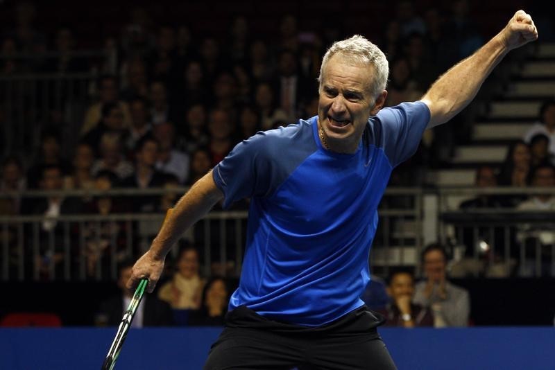 © Reuters. John McEnroe of the U.S. reacts after winning a point during his BNP Paribas Showdown friendly tennis match against compatriot Ivan Lendl in Hong Kong