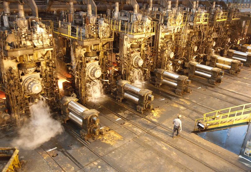 © Reuters. File photo of an employee walking inside the China Steel production factory in Kaohsiung, southern Taiwan