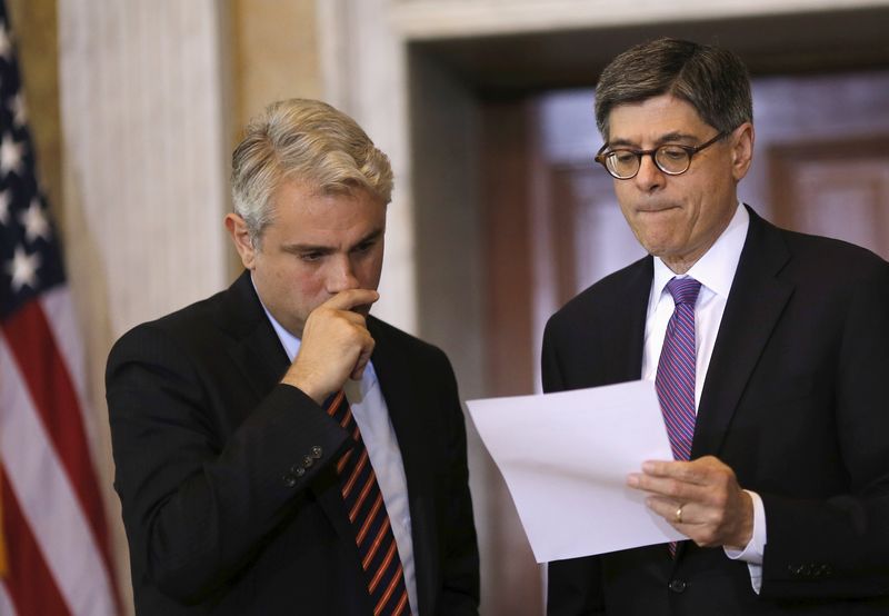 © Reuters. Treasury Secretary Lew talks with Pinschmidt, Deputy Assistant Secretary and Executive Director of the Council during a meeting of the FSOC at the Treasury Department in Washington