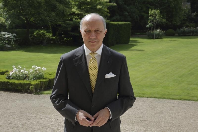 © Reuters. French Foreign Affairs Minister Fabius poses outside his office in Paris