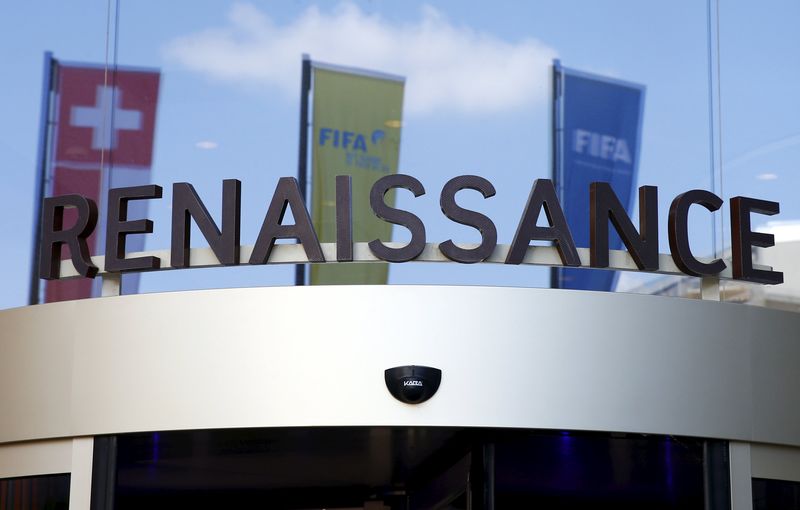 © Reuters. A Swiss and two FIFA flags are reflected in the window of the Renaissance hotel in Zurich