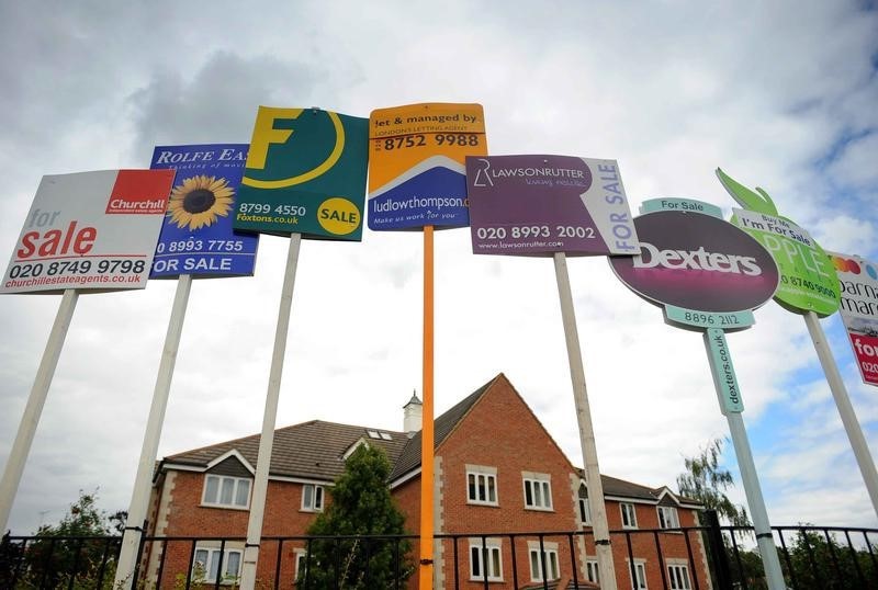 © Reuters. Residential property sales signs seen in London