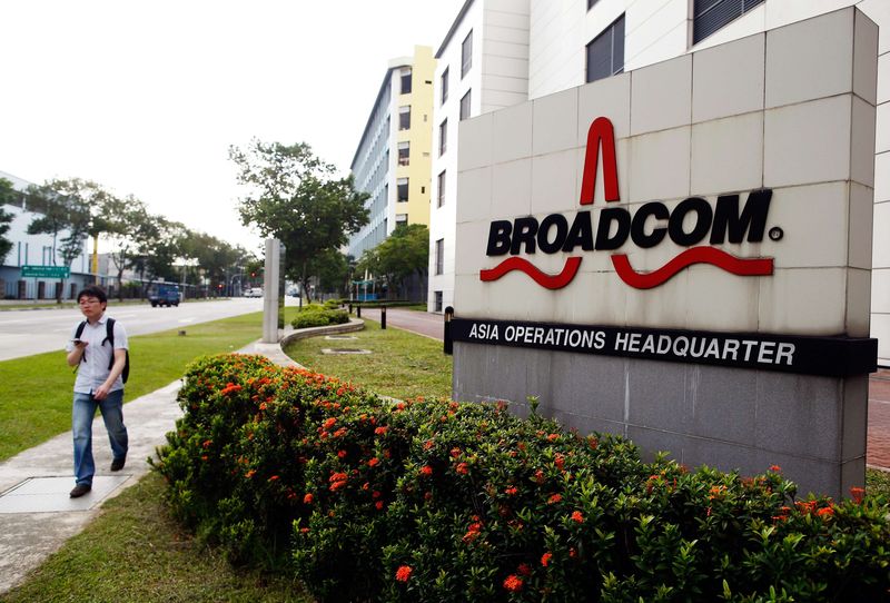 © Reuters. Man passes Broadcom's Asia operations headquarters office at an industrial park in Singapore in this file photo