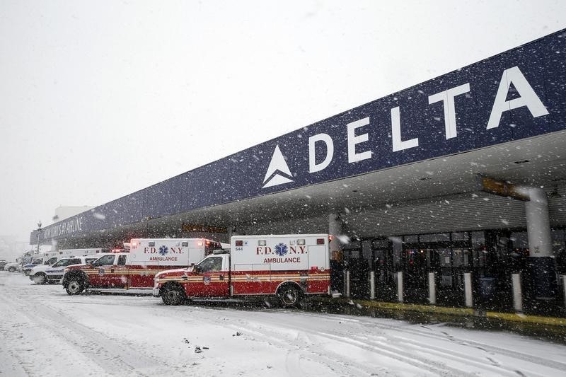 © Reuters. Ambulances are seen at LaGuardia Airport's Terminal D during a snow storm in New York