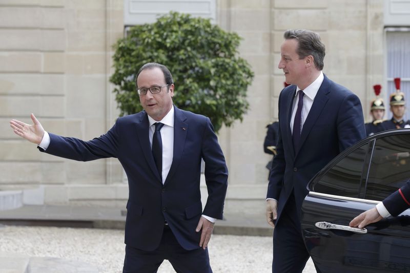 © Reuters. French President Hollande greets Britain's Prime Minister Cameron at the Elysee Palace ahead of a meeting in Paris