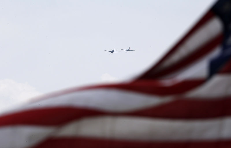 © Reuters. World War II era planes  fly over U.S. flag during ceremony to commemorate the 70th anniversary of VE Day in Washington