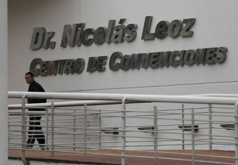 © Reuters. Private security guard walks outside Dr. Nicolas Leoz Convention Center, near the headquarters of South America's soccer confederation, CONMEBOL, in Luque