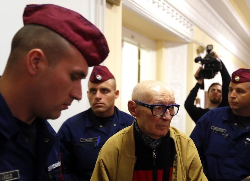 © Reuters. Former Communist Party leader Biszku escorted by police during his trial in Budapest