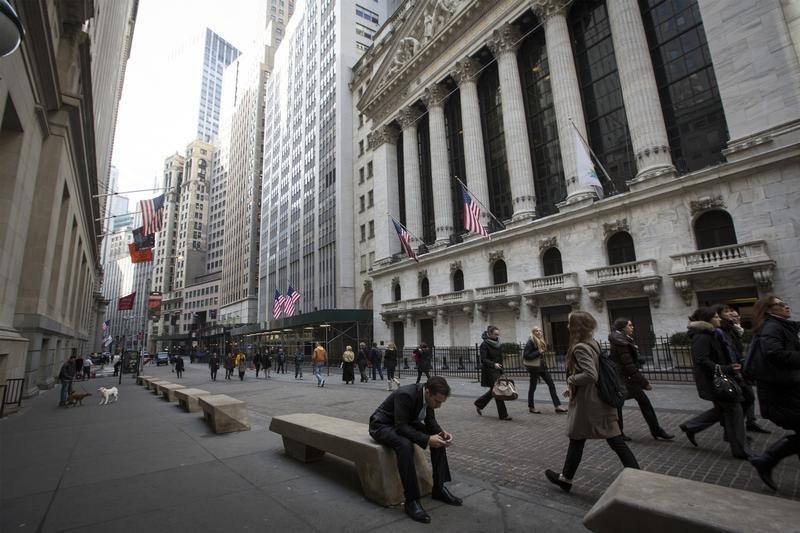 © Reuters. People walk by the New York Stock Exchange in New York's financial district