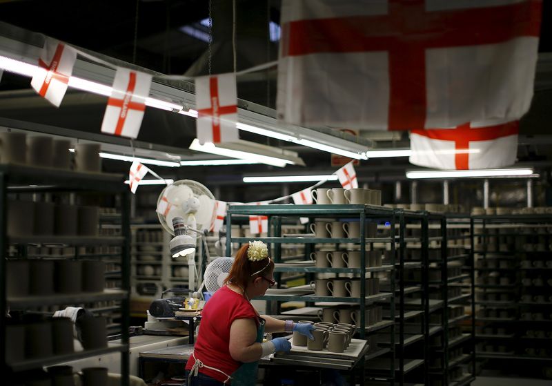 © Reuters. File photo of a worker putting handles onto cups at the Portmeirion Factory in Stoke-on-Trent