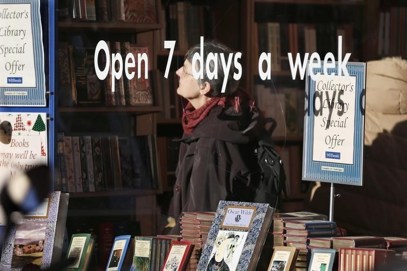 © Reuters. A customer checks books inside the WHSmith library shop in Paris