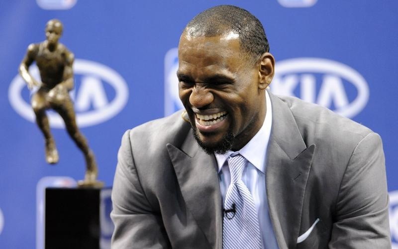 © Reuters. Miami Heat's James laughs as he waits to address the media after receiving his Most Valuable Player trophy during a news conference held by the NBA and Miami Heat in Miami