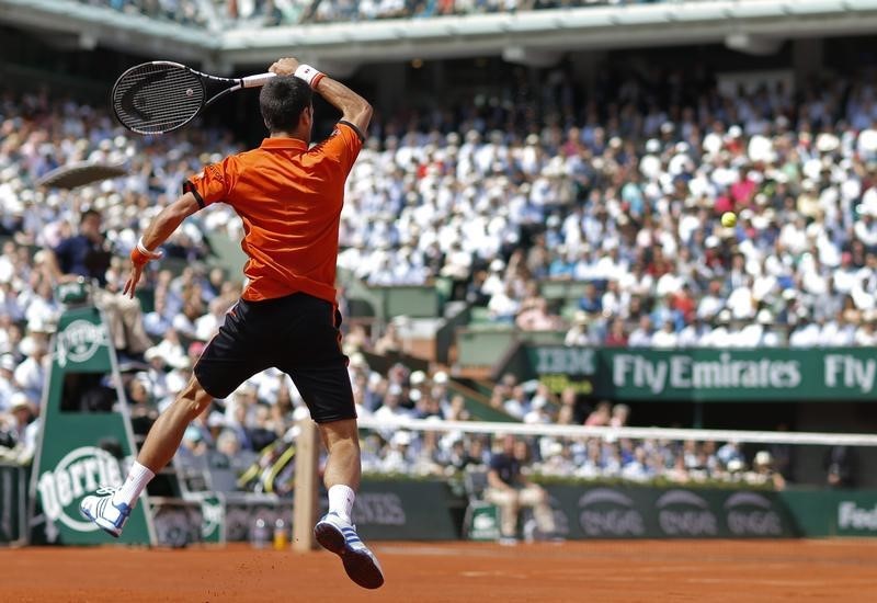 © Reuters. Novak Djokovic of Serbia returns the ball to Rafael Nadal of Spain during their men's quarter-final match during the French Open tennis tournament at the Roland Garros stadium in Paris