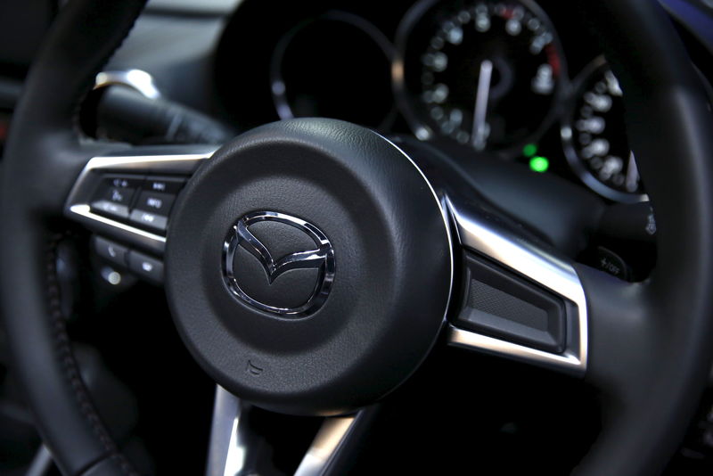 © Reuters. The logo of Mazda Motor is seen on a steering wheel of the company's new open-top sports car "Roadster", also known as "MX-5" in overseas markets, in Tokyo