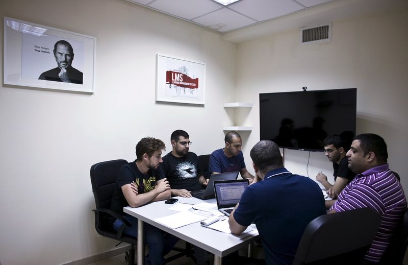© Reuters. Jabbour, founder and CEO of start-up Edunation, meets with his team at their offices in Nazareth