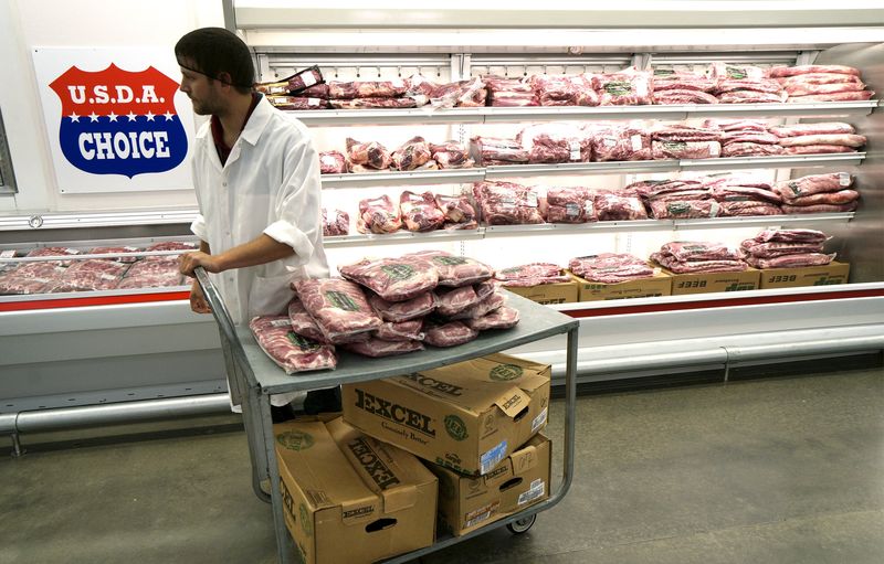 © Reuters. A meat cutter works at the Wal-Mart owned Sam's Club in Bentonville

