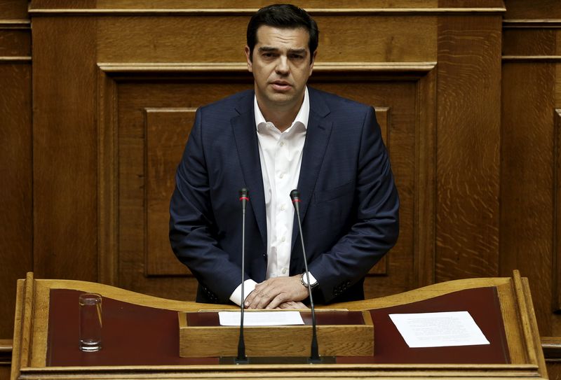 © Reuters. Greek PM Tsipras delivers a speech during a parliamentary session to brief lawmakers over the ongoing talks with the country's lenders, in Athens, Greece