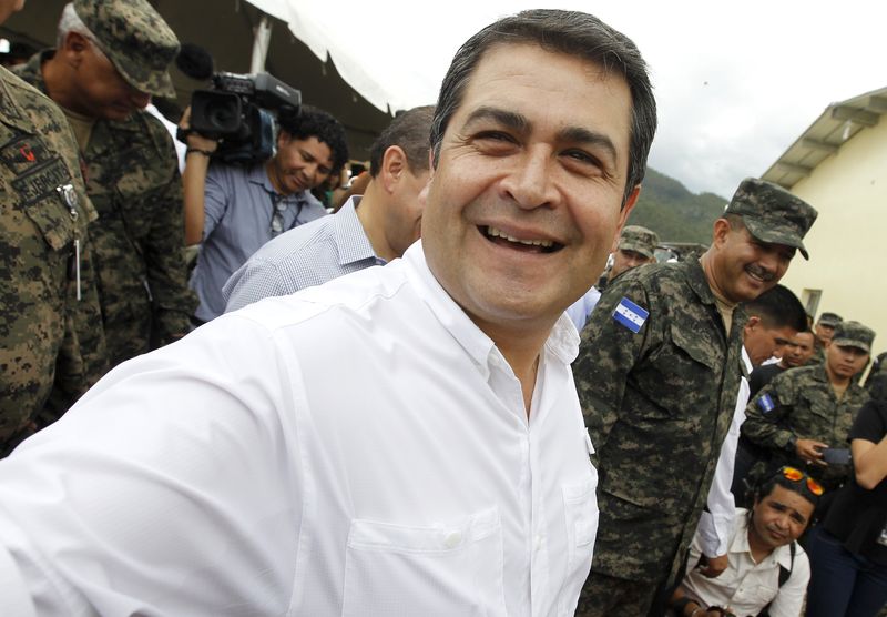 © Reuters. Honduras' President Juan Orlando Hernandez smiles during the inauguration of a military facility in Tegucigalpa