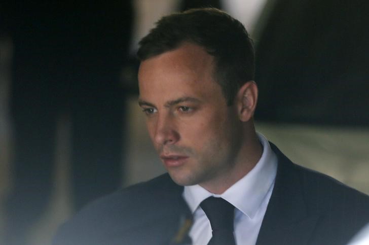 © Reuters. South African Olympic and Paralympic sprinter Pistorius is led to a prison van after his sentencing in Pretoria