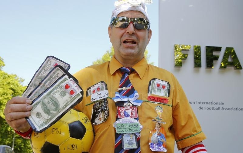 © Reuters. An unidentified protestor stands in front the entrance of the FIFA headquarters in Zurich