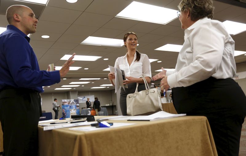 © Reuters. Kathleen Blake, who said she is seeking job in sales, is greeted by prospective employers during job hiring event for marketing, sales and retail positions in San Francisco