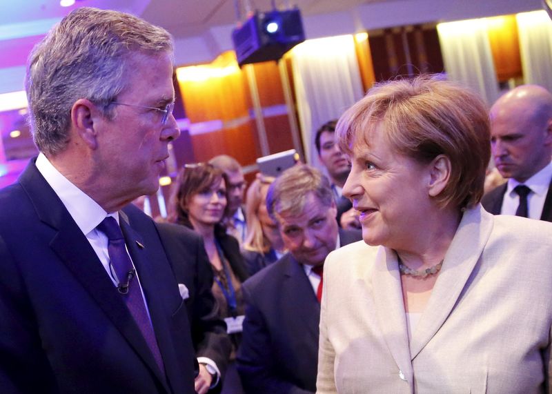 © Reuters. German Chancellor Merkel talks to former Florida Governor and potential Republican presidential candidate Bush after he addressed the CDU party economic council in Berlin 