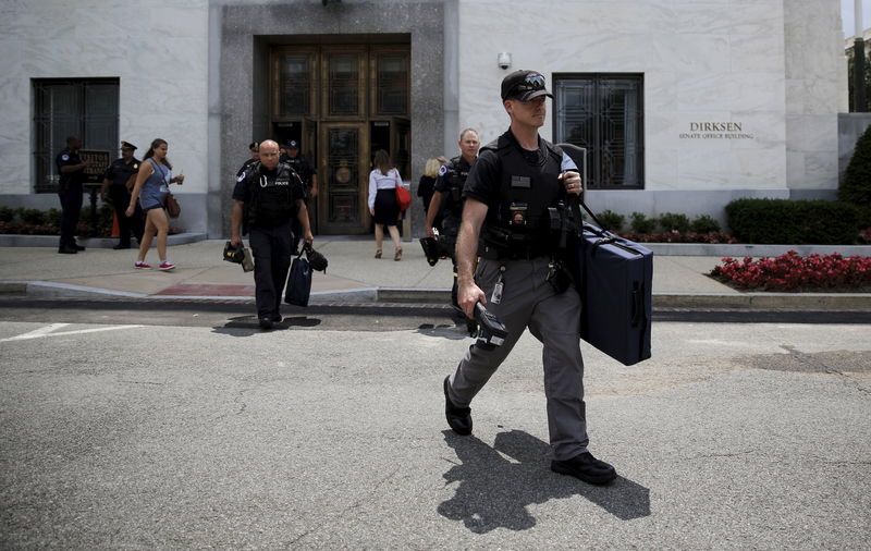 © Reuters. Police officers leave Dirksen building after reports of suspicious packages found on Capitol Hill in Washington