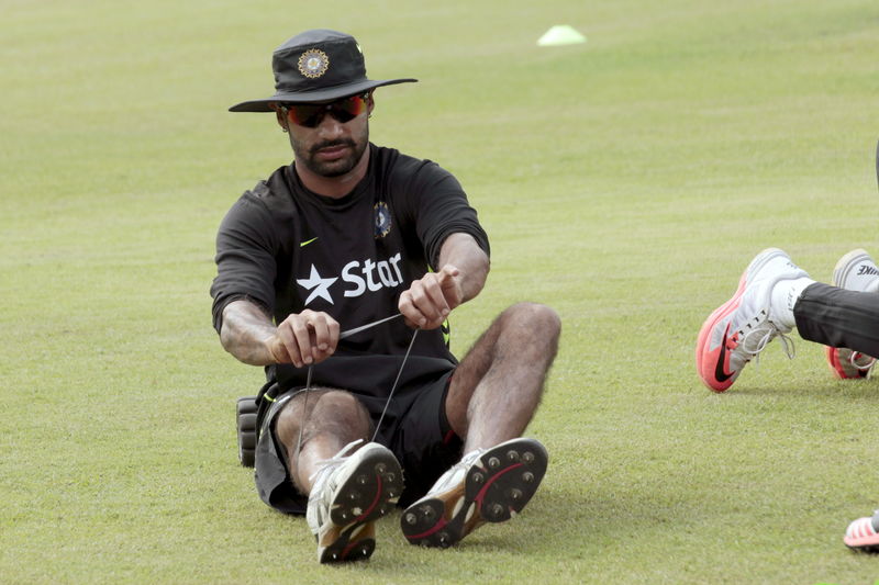 © Reuters. Indian opener Shikhar Dhawan exercises during a practice session in Dhaka