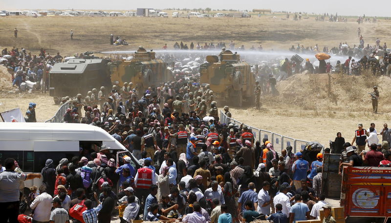 © Reuters. Militares turcos usam canhão de água contra refugiados em fronteira com a Síria perto de Akcakale