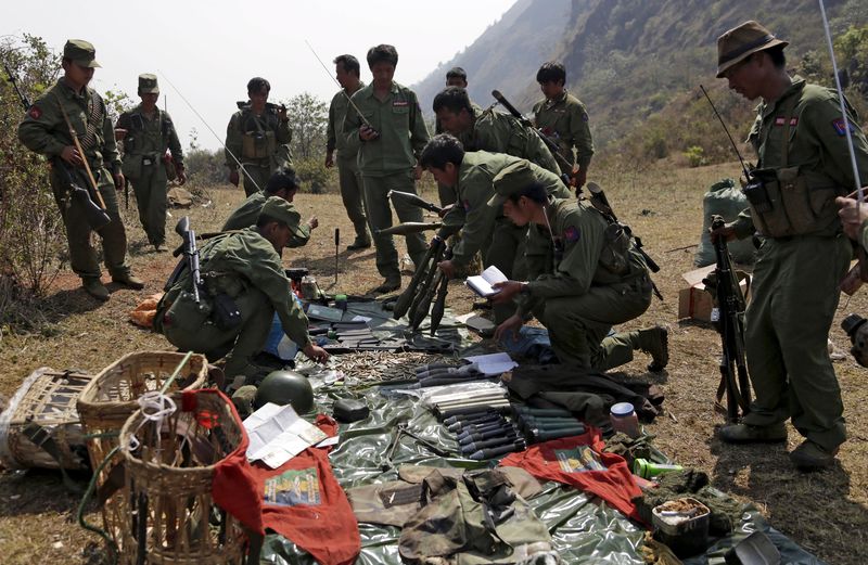 © Reuters. File photo of rebel soldiers of the Myanmar National Democratic Alliance Army examining weapons and ammunition at military base in Kokang region