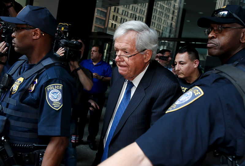 © Reuters. Former U.S. House of Representatives Speaker Dennis Hastert is surrounded by officers as he leaves federal court after pleading not guilty to federal charges of trying to hide large cash transactions and lying to the FBI in Chicago