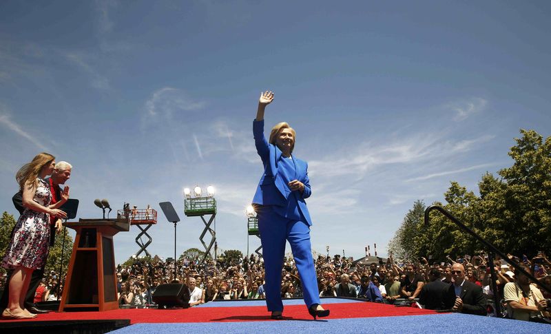 © Reuters. Hillary Clinton waves to the crowd as she is joined onstage by daughter Chelsea and husband former President Clinton after delivering her "official launch speech" at rally in New York City