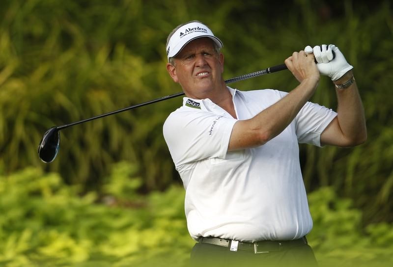 © Reuters. Montgomerie of Scotland tees off during the first round of the Barclays Singapore Open golf tournament in Sentosa