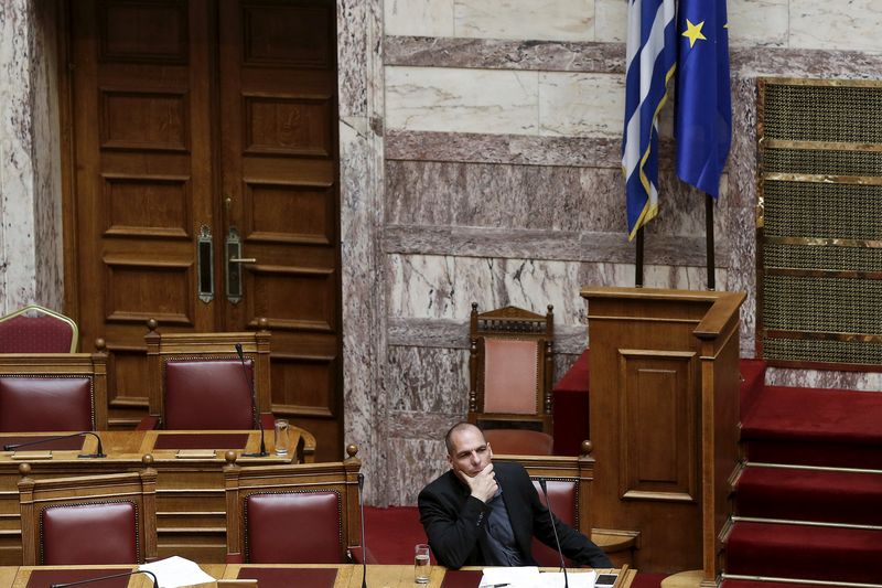 © Reuters. Greek Finance Minister Varoufakis listens to a question during a parliamentary session in Athens