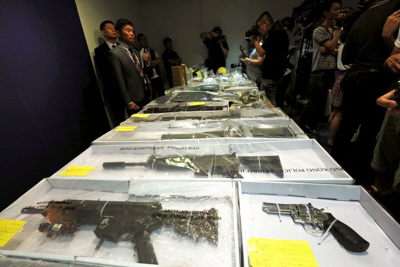 © Reuters. Air rifles seized along with explosives are displayed during a news conference at police headquarters in Hong Kong