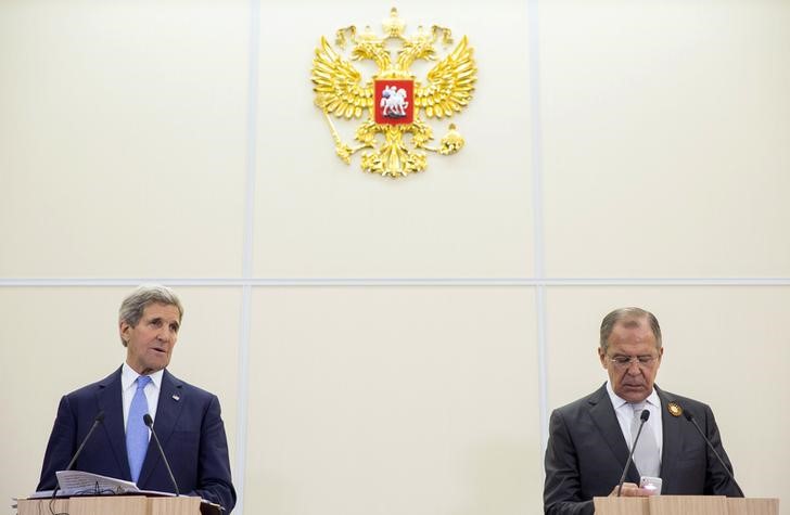 © Reuters. Ministro das Relações Exteriores da Rússia, Sergei Lavrov (direita) checa telefone durante entrevista coletiva ao lado do secretário de Estado dos EUA, John Kerry, em Sochi